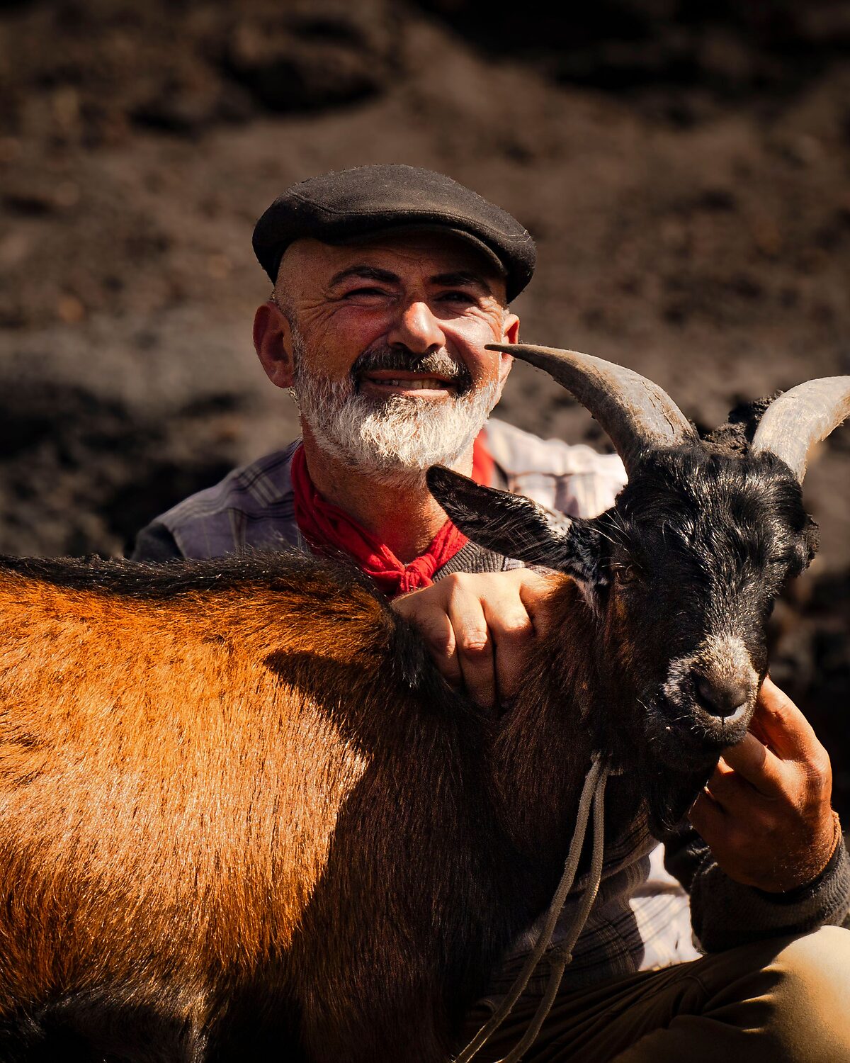 Farmer with one of his goats on the home place