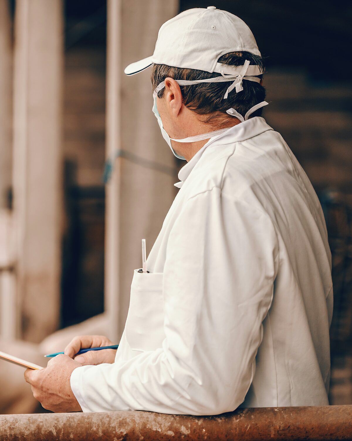 Inspector recording observations beside a plant holding pen